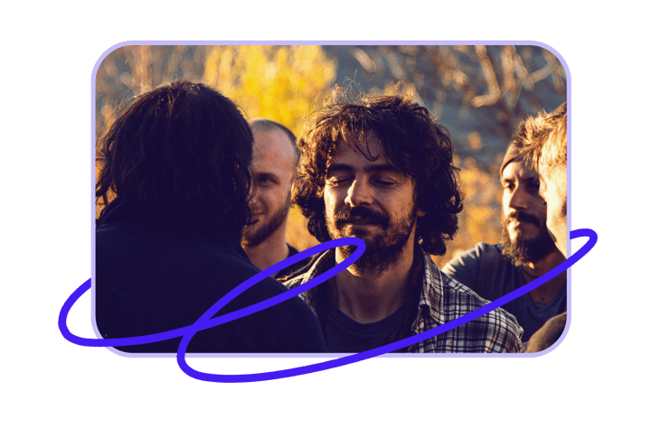 A joyful group of adults interacting in a sunny outdoor setting, showcasing friendship and happiness.